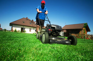 A picture of someone mowing a lawn